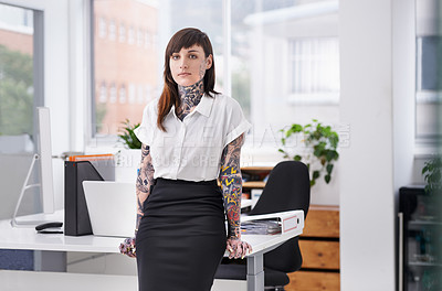 Buy stock photo A tattoo-covered young businesswoman in her office