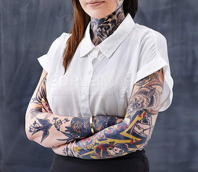 Buy stock photo A cropped studio shot of a young professional with tattoos on her neck and arms