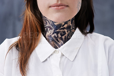 Buy stock photo A cropped studio shot of a young professional with tattoos on her neck and arms