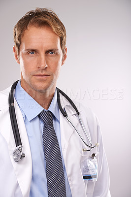 Buy stock photo Man, doctor and professional in studio, portrait and medical expert on gray background. Male person, healthcare and pride for cardiologist career, serious face and trustworthy specialist for medicare
