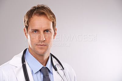 Buy stock photo Cropped studio portrait of a serious young male doctor