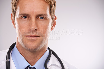 Buy stock photo Doctor, man and portrait in studio for health, medic or diagnosis with stethoscope for job on mockup. Young person or expert and serious and confident for career, medicine and specialist for medical 