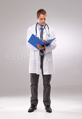 Buy stock photo Clipboard, doctor and man in studio writing notes for medical research, insurance and report for hospital. Healthcare, clinic and worker with documents for consulting and planning on gray background
