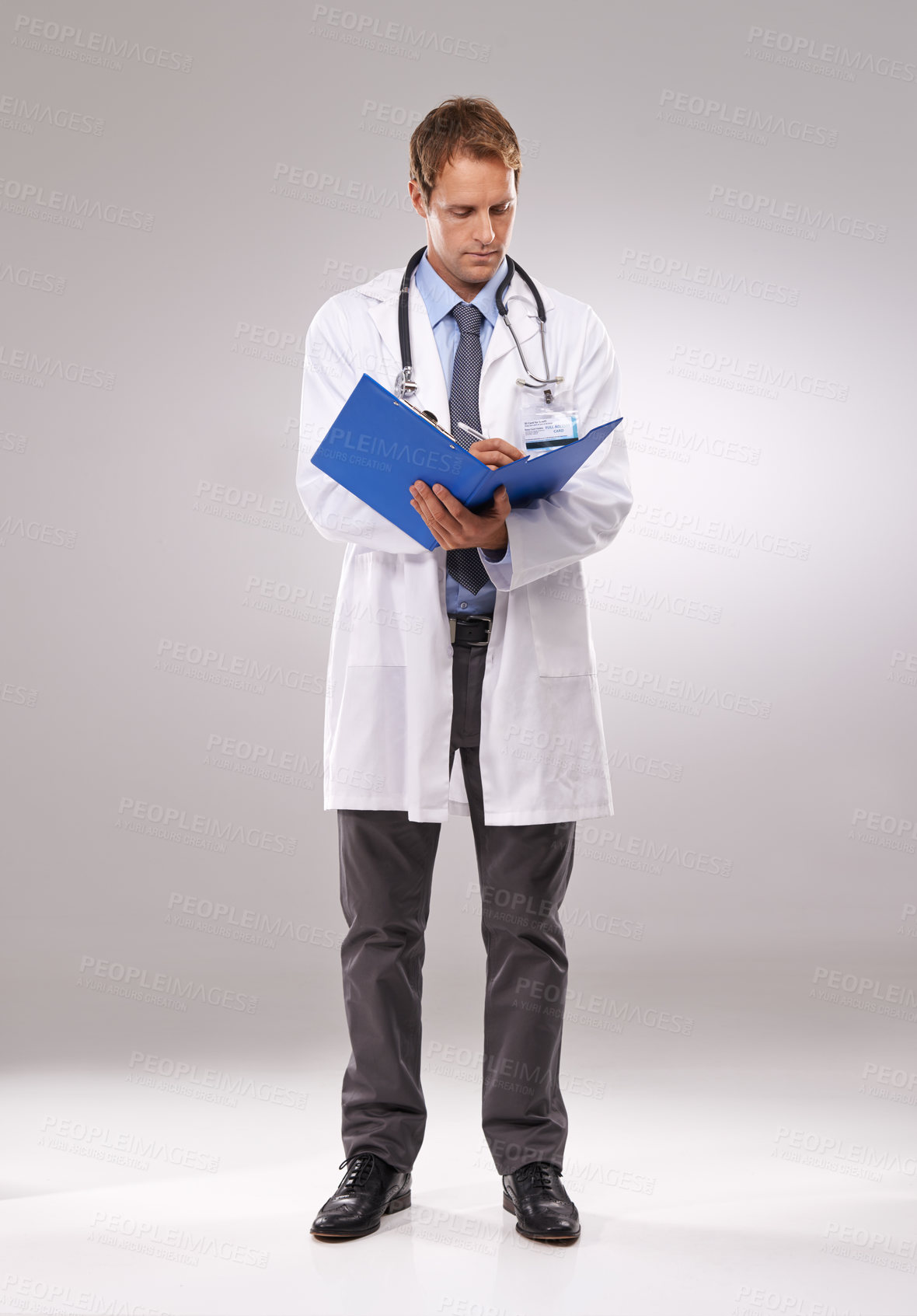 Buy stock photo Clipboard, doctor and man in studio writing notes for medical research, insurance and report for hospital. Healthcare, clinic and worker with documents for consulting and planning on gray background