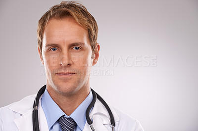 Buy stock photo Cropped studio portrait of a confident young male doctor