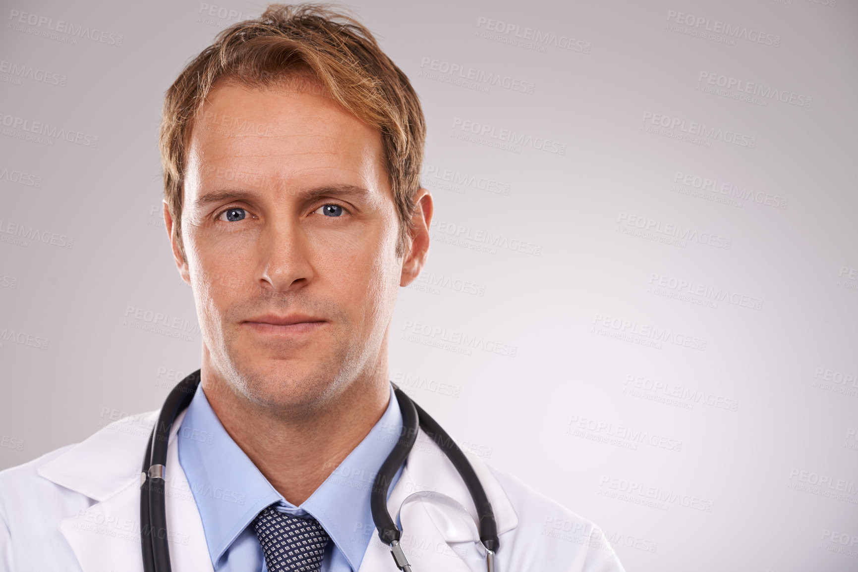 Buy stock photo Cropped studio portrait of a confident young male doctor