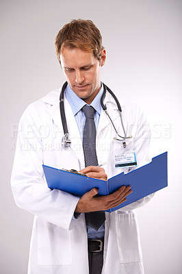 Buy stock photo Clipboard, writing and doctor in studio for medical report, insurance and research for hospital. Healthcare, clinic and worker with documents for consulting, wellness and planning on gray background