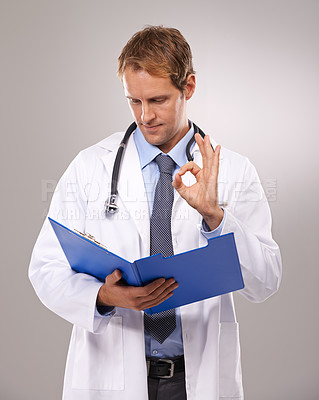 Buy stock photo Clipboard, doctor and man in studio with okay sign for medical research, insurance and good news. Healthcare, hospital and worker with hand gesture for consulting, yes and planning on gray background