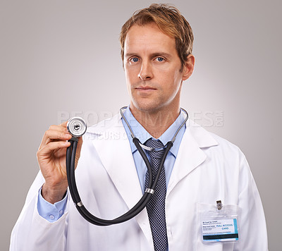 Buy stock photo Stethoscope, doctor and portrait of man in studio for medical research, consulting and wellness. Healthcare, hospital and worker with equipment for cardiology, service and help on gray background