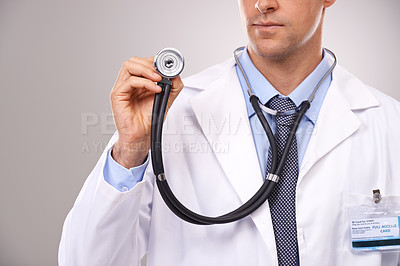 Buy stock photo Stethoscope, doctor and hands of man in studio for medical research, consulting and wellness. Healthcare mockup, hospital and worker with equipment for cardiology, service and help on gray background