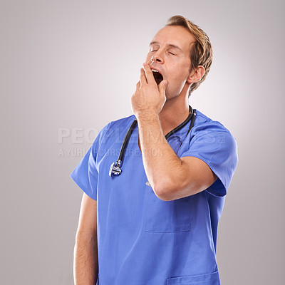 Buy stock photo Doctor, studio and yawn for overworked, tired and burnout with stethoscope for job. Man, specialist and stress for professional, medic and health care or medical pressure isolated on white background