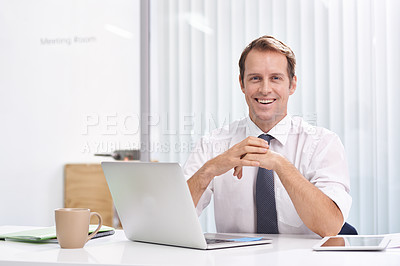 Buy stock photo Portrait of a handsome and confident young businessman sitting at his office desk