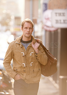 Buy stock photo Morning, walking and man in city with fashion for travel, commute and journey in urban town with bag. Sunshine, tourism and person with trendy style for holiday, vacation and adventure on weekend