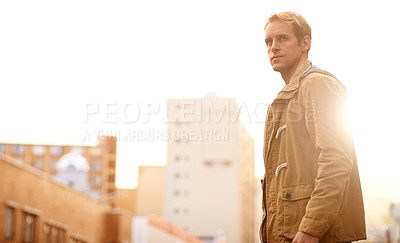 Buy stock photo Cropped shot of a handsome man walking through a city