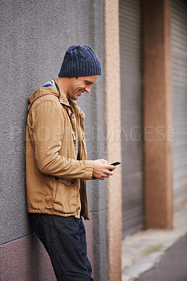 Buy stock photo Happy, typing and man in city with phone for social media, networking and online text message in street. Travel, weekend and person on cellphone for website, internet search and chat in urban town