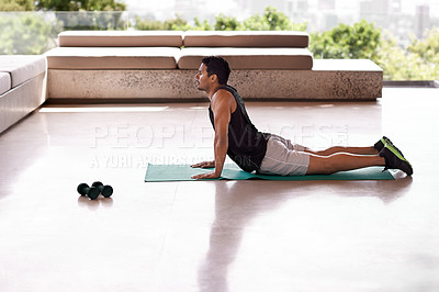 Buy stock photo Shot of a handsome man doing yoga on a balcony