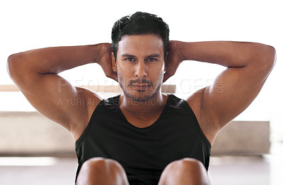 Buy stock photo Portrait of a focussed man doing sit-ups at home