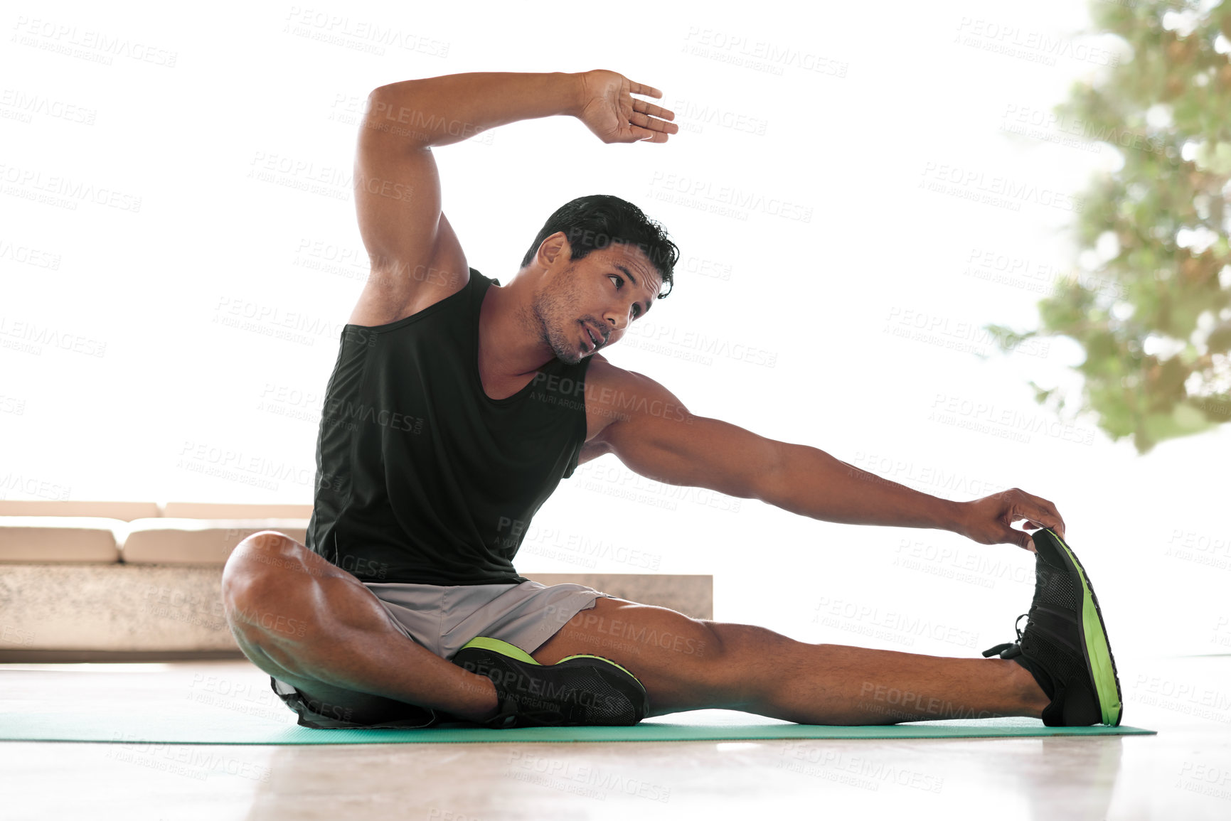 Buy stock photo Full length shot of a handsome man stretching to touch his foot