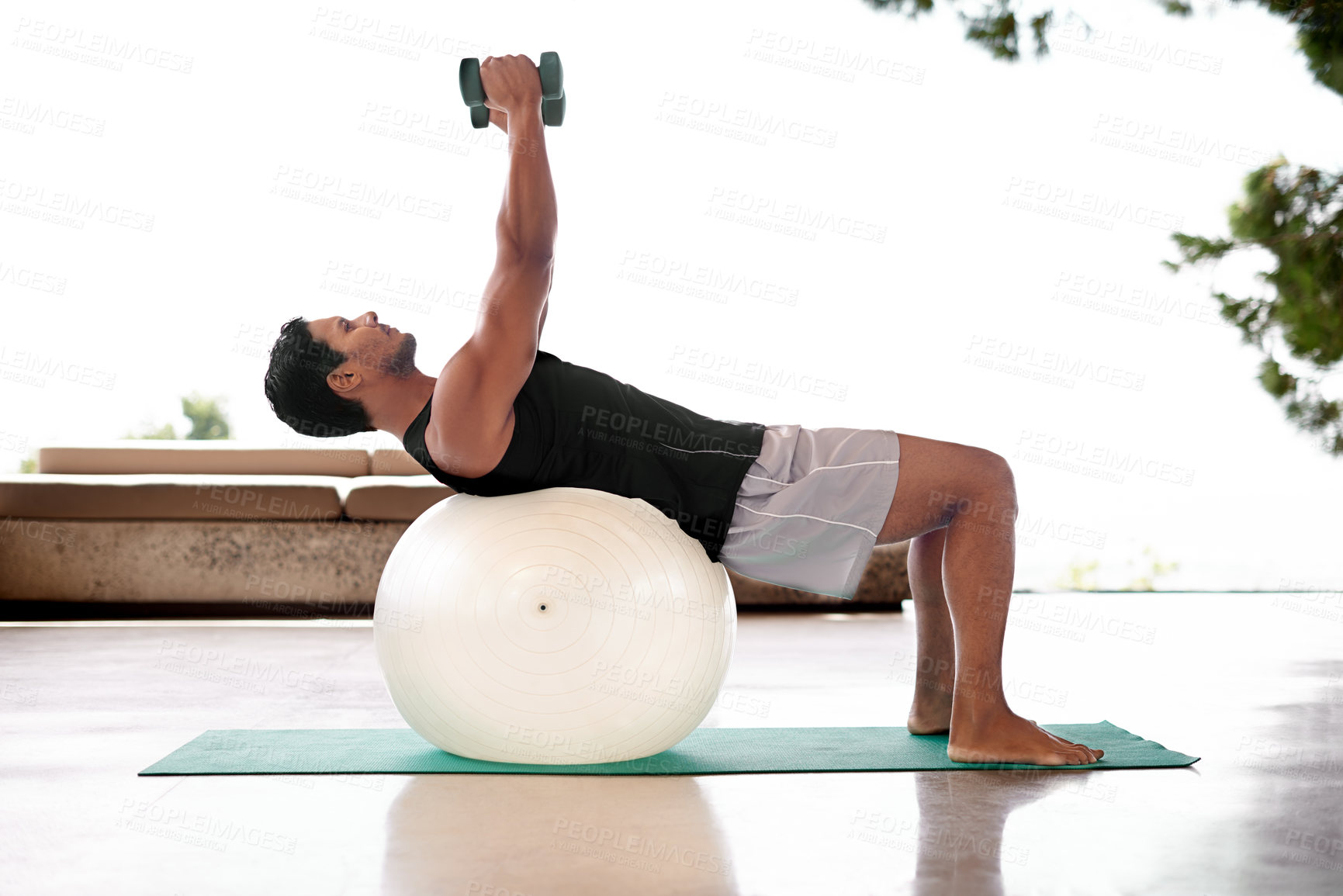 Buy stock photo Man, dumbbell and exercise ball on yoga mat or flexibility training for healthy mobility, fitness or weightlifting. Male person, equipment and workout strength for sport challenge, gym or balance