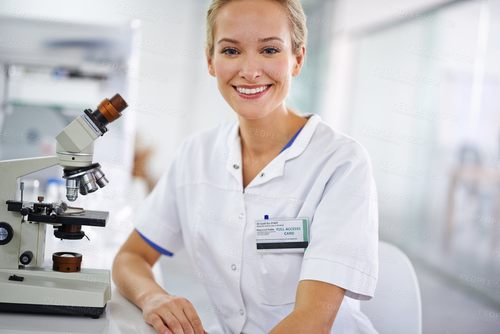 Buy stock photo Shot of a beautiful woman in a laboratory working with a microscope