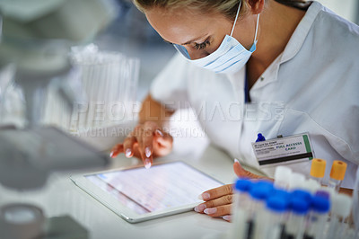 Buy stock photo A young researcher recording her results on a tablet in t he lab