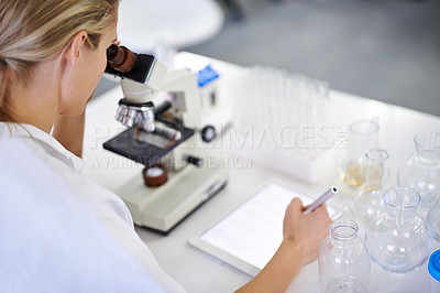 Buy stock photo Shot of a beautiful young scientist recording her findings on a tablet