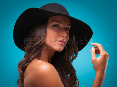 Buy stock photo Woman, portrait and beauty in studio, cosmetics and bare shoulders on blue background. Female person, hat and face for dermatology on mockup space, accessories and isolated on backdrop for aesthetic