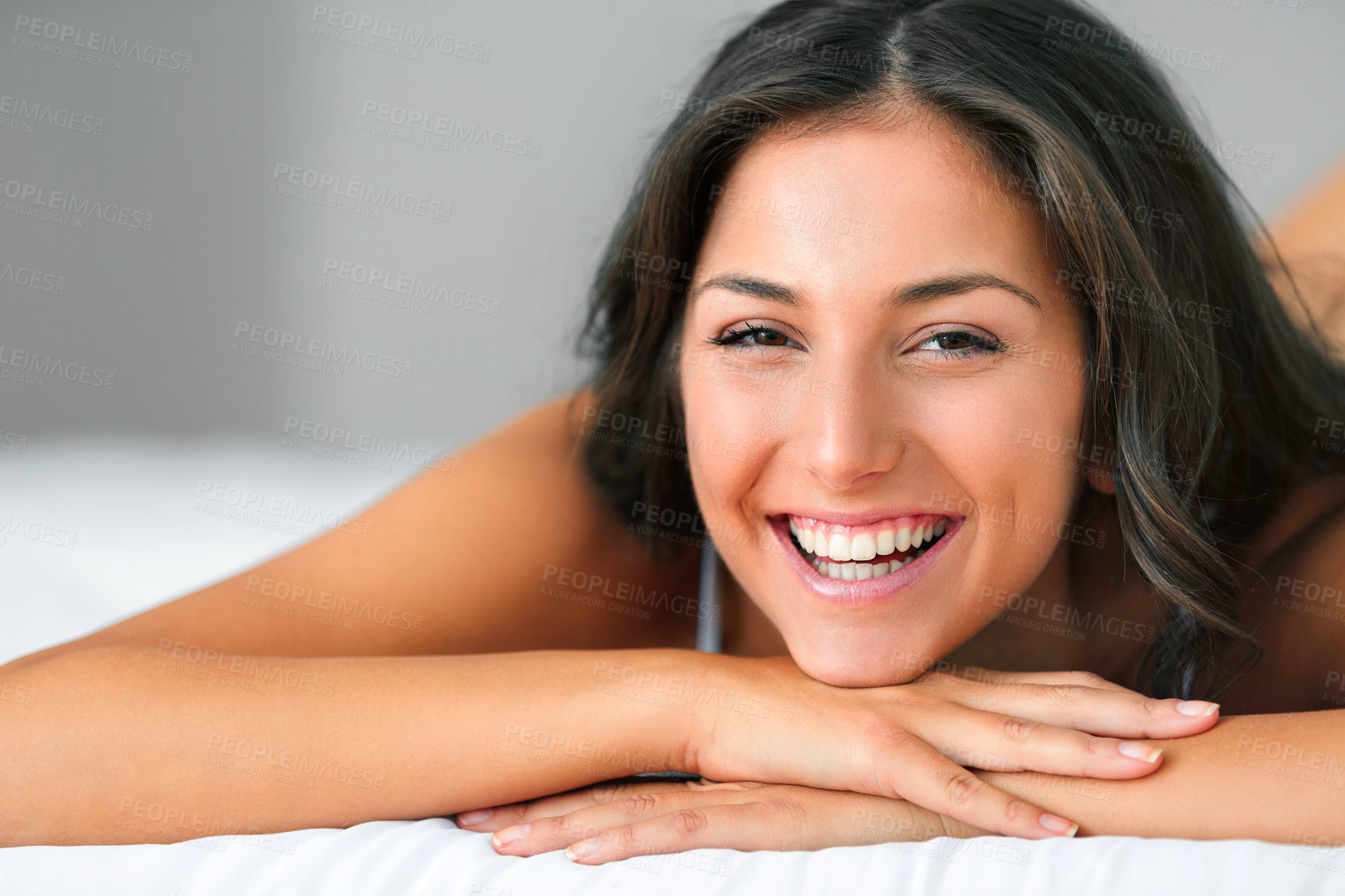Buy stock photo Shot of a beautiful young woman relaxing on her bed