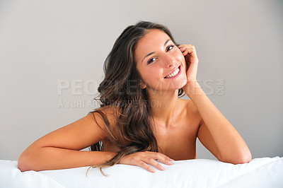 Buy stock photo Shot of a beautiful young woman relaxing on her bed