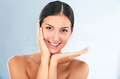 Buy stock photo Shot of a beautiful young woman in studio feeling her soft skin