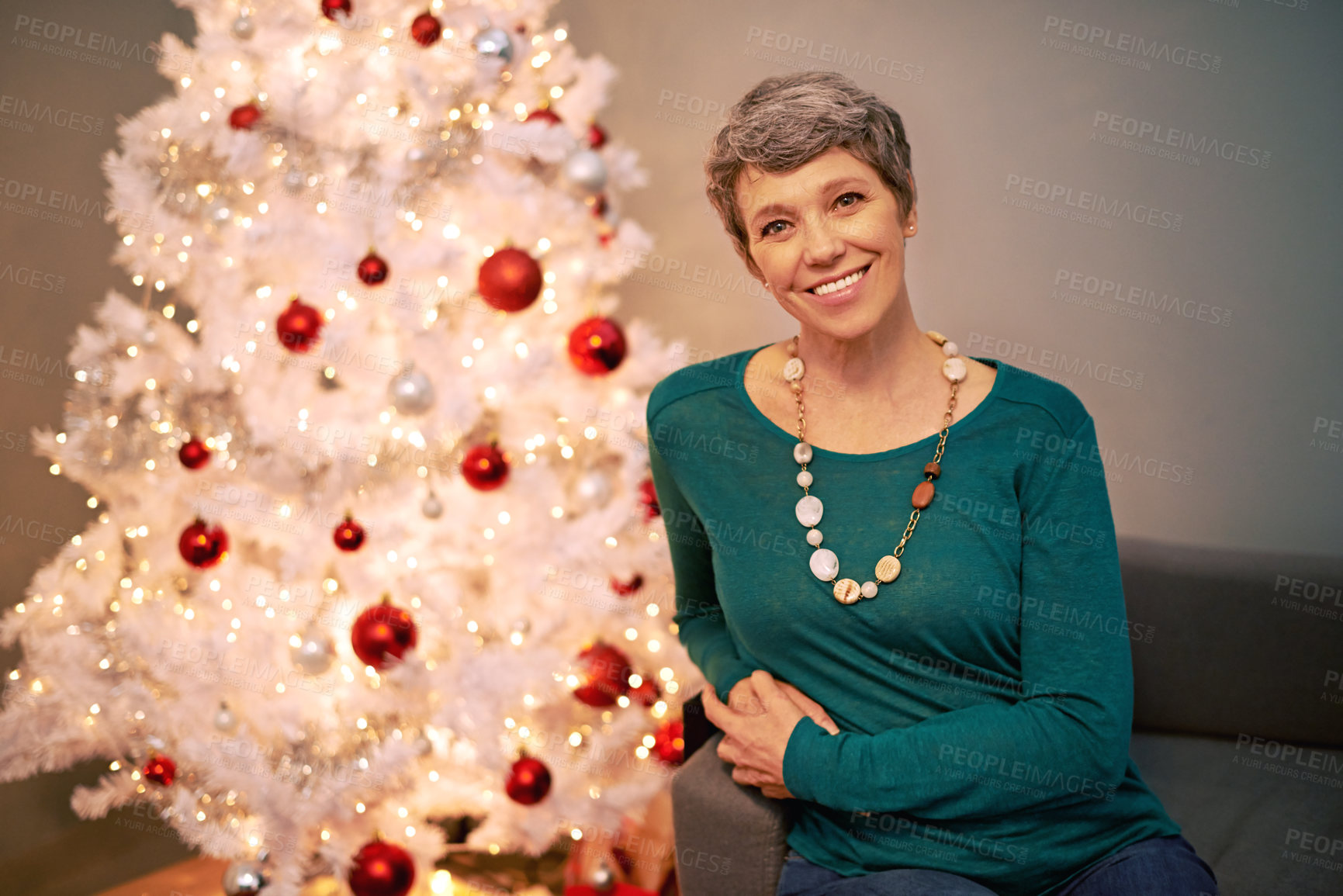Buy stock photo Christmas, tree and portrait of mature woman in home for holiday, festival or celebration on vacation. Happy, person and relax on sofa with festive xmas decoration in living room and enjoy retirement