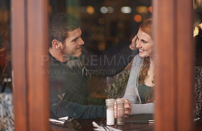 Buy stock photo Couple, smile and holding hands on date at restaurant for bonding, romance and healthy relationship with relax. Man, woman and affection at cafe with happiness, trust and love on anniversary vacation