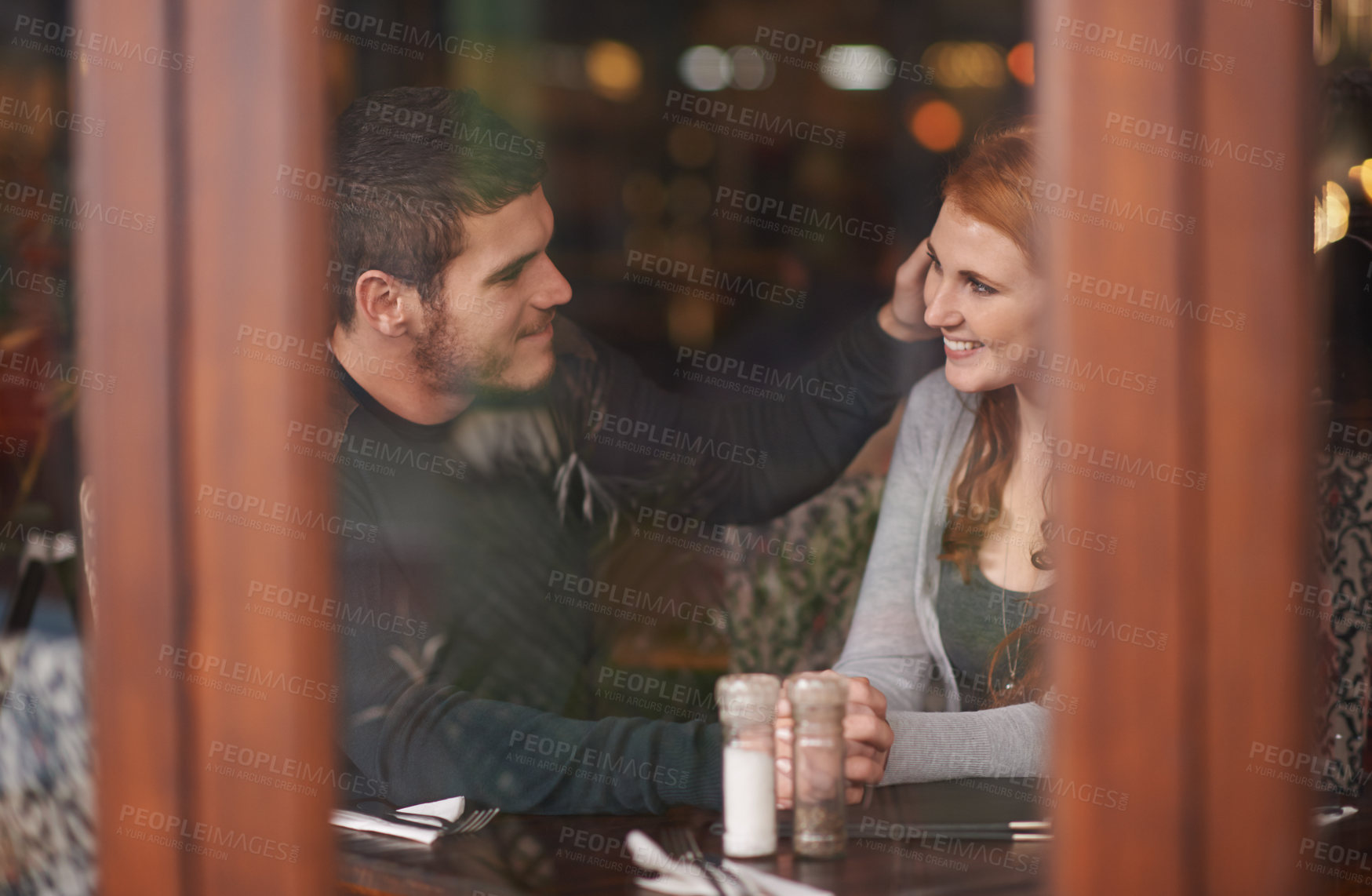 Buy stock photo Couple, smile and holding hands on date at restaurant for bonding, romance and healthy relationship with relax. Man, woman and affection at cafe with happiness, trust and love on anniversary vacation