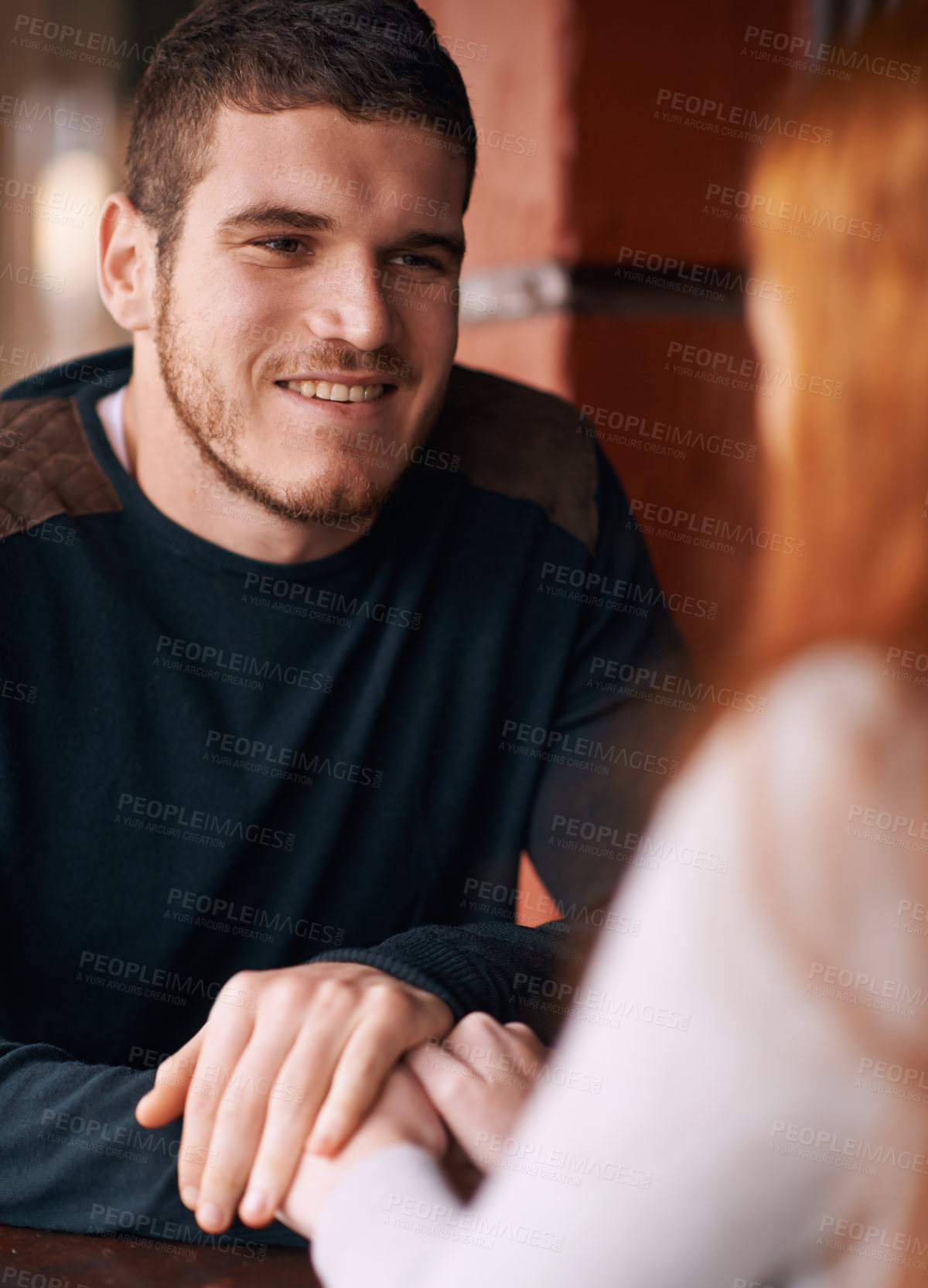 Buy stock photo Happy couple, bonding and holding hands with romance in support, trust or care at indoor restaurant. Young man or woman with smile in happiness for social, conversation or friendly discussion at cafe