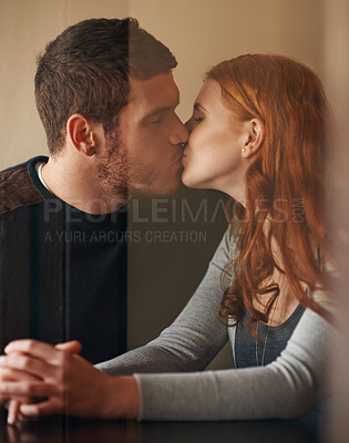 Buy stock photo Happy couple, kiss and love with affection for support, intimacy or romance together at indoor cafe. Man and woman holding hands and touching for date, relationship or romantic bonding at coffee shop