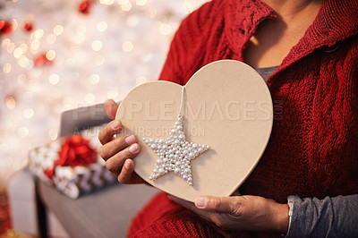 Buy stock photo Cropped view of a woman holding a heart shaped Christmas gift