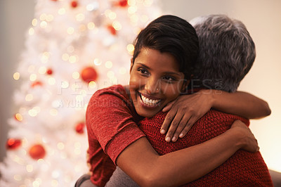 Buy stock photo A senior woman receiving a hug from her daughter on Christmas