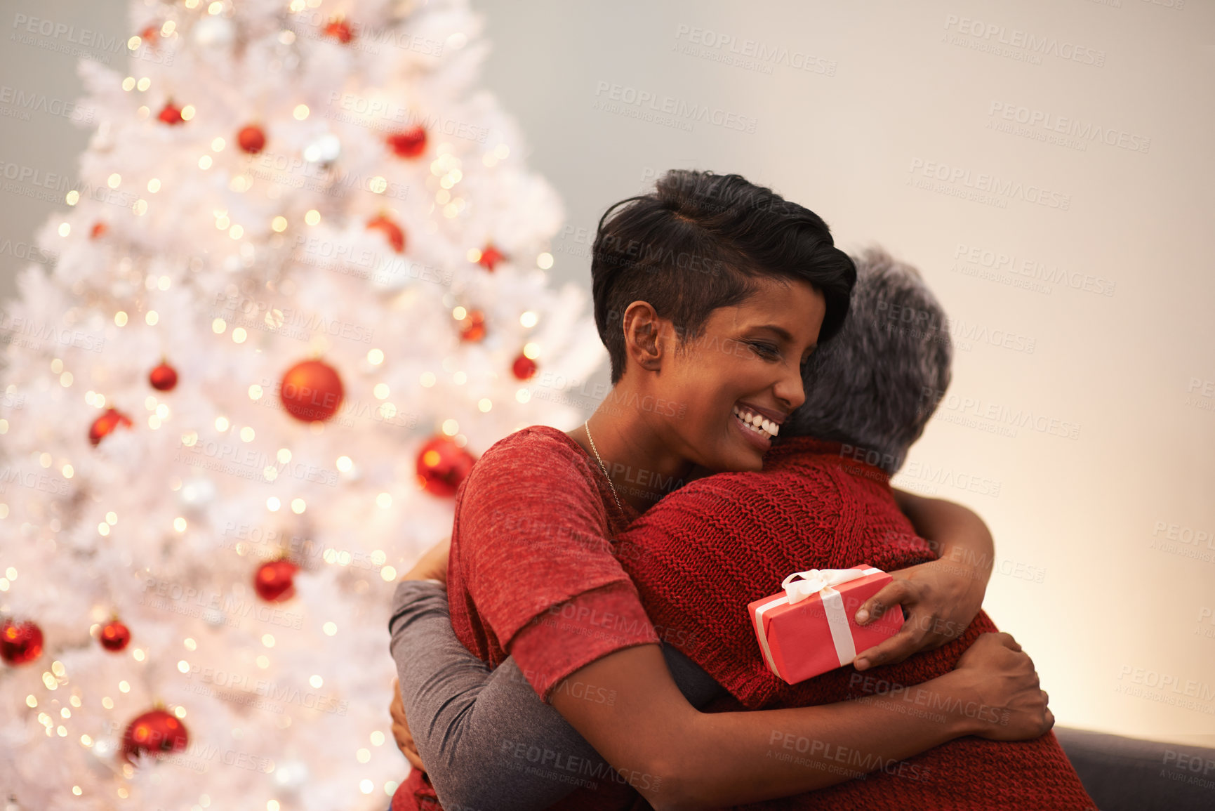 Buy stock photo Senior, mother and daughter hug on Christmas with gift,  happiness with box and celebrate holiday at home. Festive season, gratitude and present with happy people, family and bonding with love