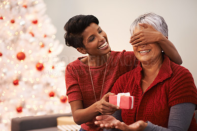 Buy stock photo Senior, mother and daughter with surprise gift for Christmas,  happiness with box and celebrate holiday at home. Festive season, decoration and present with happy people, family and bonding with love