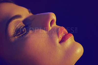 Buy stock photo Studio shot of a beautiful young woman with artistic lighting