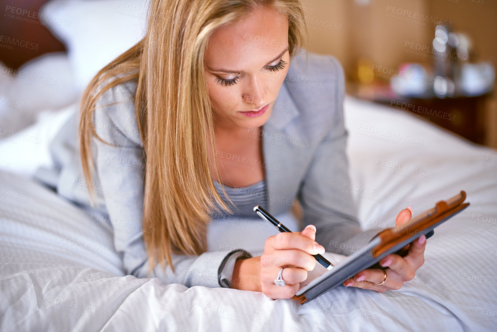 Buy stock photo Business, woman and technology on bed with writing for corporate planning, digital tablet and work schedule. Professional, person and touchscreen for writing review notes and internet search in hotel