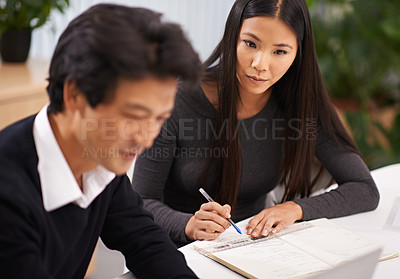 Buy stock photo Happy, asian business people and writing notes for project research, book and collaboration in office. Japanese woman, man and hr consulting in workplace and planning or teamwork for brainstorming
