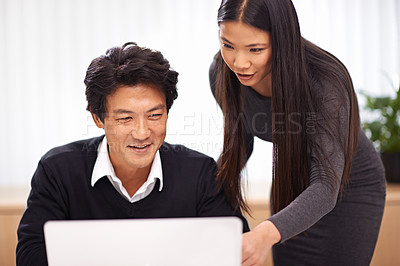 Buy stock photo Help, mentor and teamwork on laptop in office with businessman learning from support of woman. Feedback, advice and manager training asian man on computer in collaboration and reading online research
