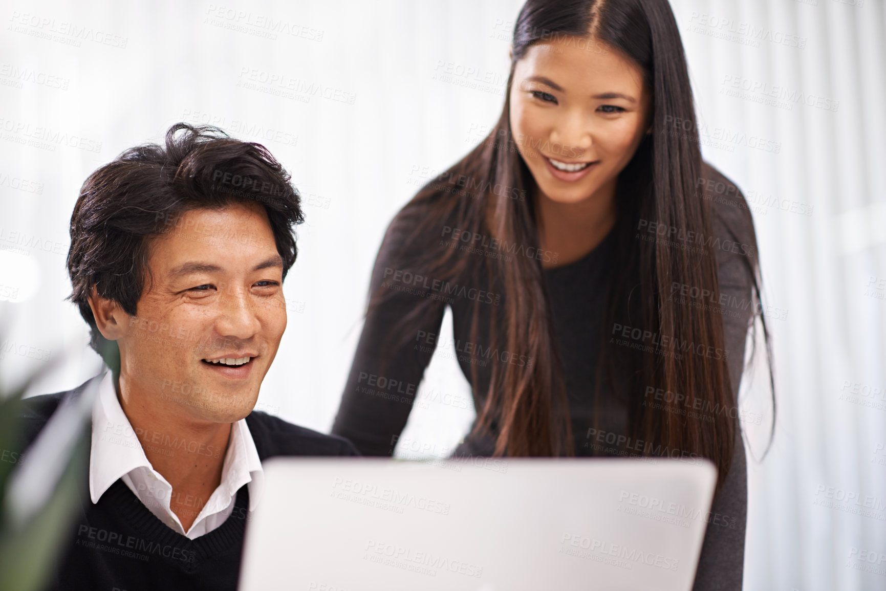 Buy stock photo Happy, mentor and teamwork on laptop in office with businessman learning from support of woman. Feedback, advice or manager training asian man on computer in collaboration and reading online research
