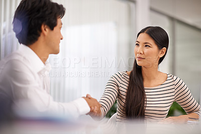 Buy stock photo Business people, handshake and agreement with colleague for meeting or deal together at the office. Young asian man and woman holding or shaking hands in b2b, greeting or partnership at the workplace