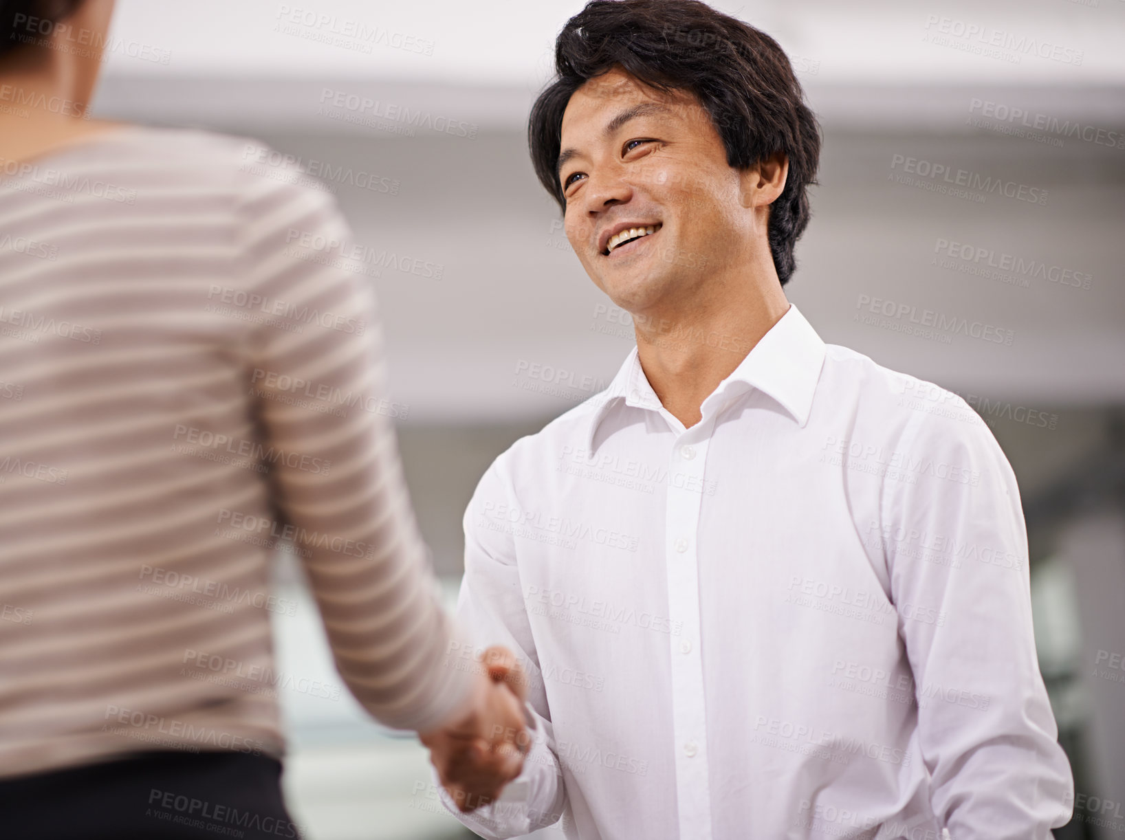 Buy stock photo Happy businessman, handshake and meeting with colleague for agreement, deal or proposal together at office. Young asian man or employee shaking hands for b2b, greeting or partnership at the workplace