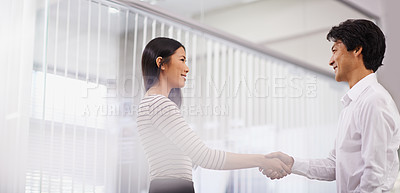 Buy stock photo Happy, business people and handshake with team for meeting, agreement or deal together at the office. Young asian man and woman shaking hands for b2b, greeting or partnership at the workplace
