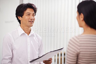 Buy stock photo Office, documents and Asian business people in discussion, conversation and talking. Professional meeting, creative agency and man and woman with project for planning, collaboration and teamwork