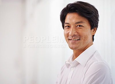 Buy stock photo Portrait of a handsome businessman smiling at the camera