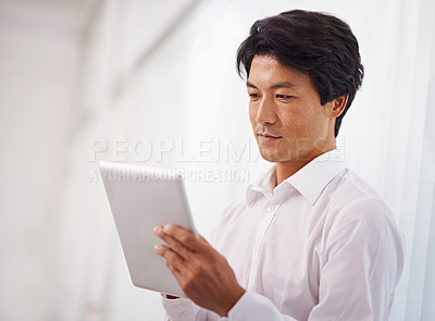 Buy stock photo Tablet, professional and asian business man online for reading email, communication and internet research in office. Corporate, technology and Japanese male employee for search, website and planning